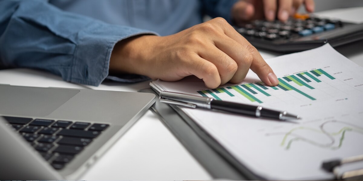 Business professional reviewing SEO analytics report with graphs and data insights on revenue growth.