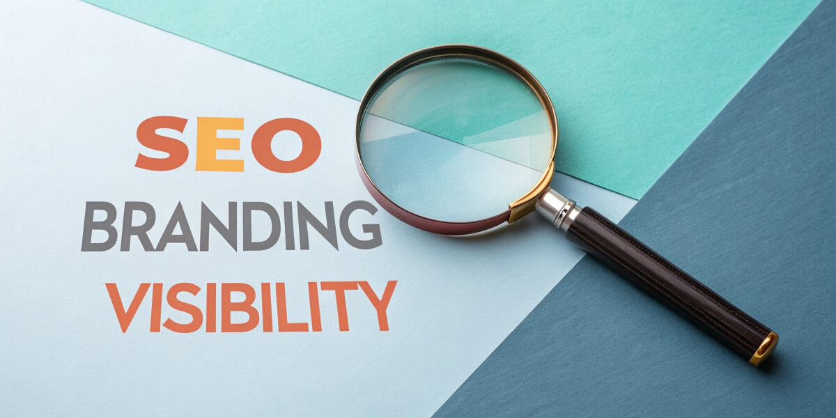 A magnifying glass over the words SEO, Branding, and Visibility, symbolising the focus on enhancing brand recognition and search engine visibility.